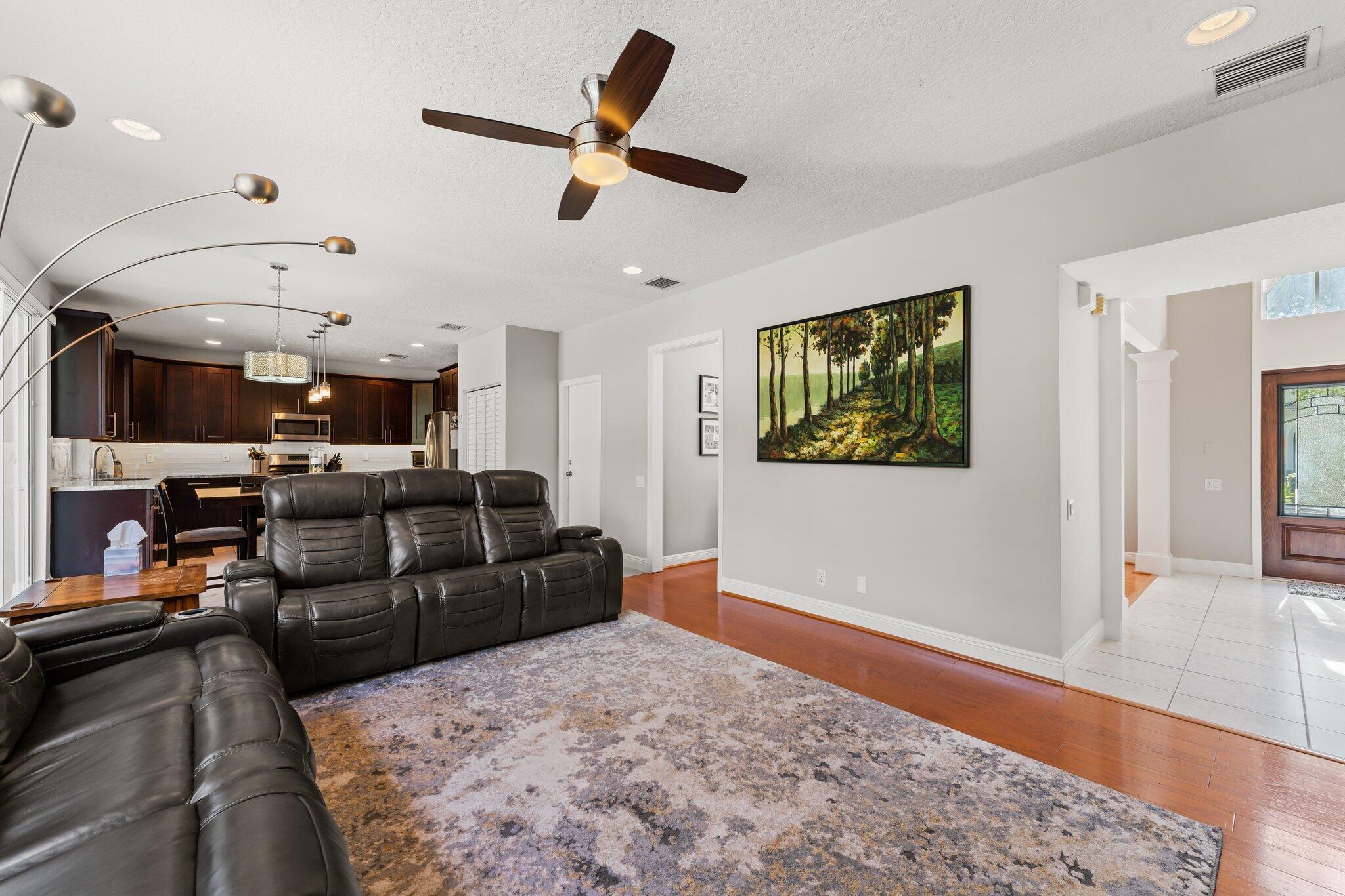 203 Anhinga Lane Jupiter, FL 33458 - Photo 16 of 63 a living room with furniture and a wooden floor
