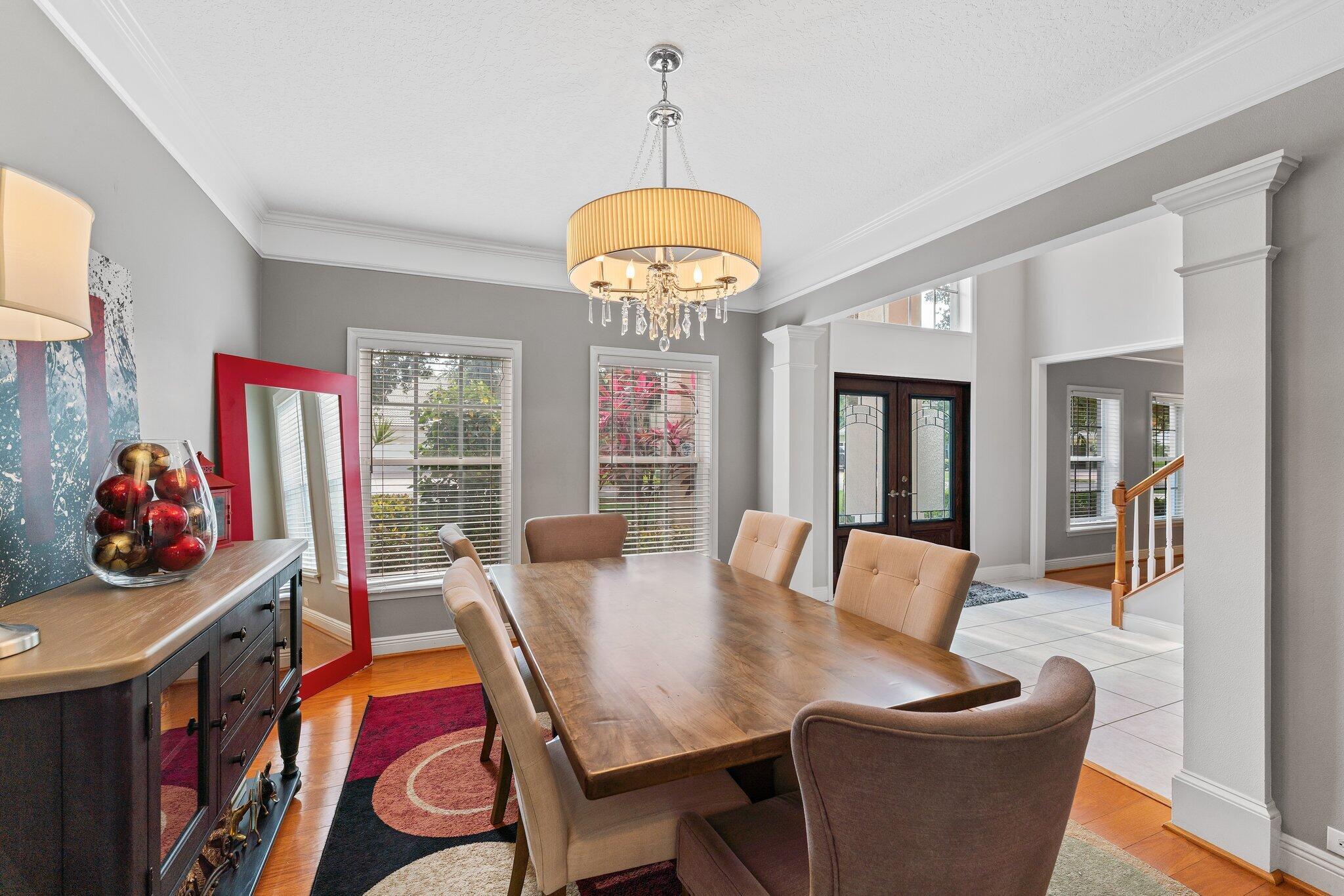 203 Anhinga Lane Jupiter, FL 33458 - Photo 17 of 63 a view of a dining room with furniture and chandelier