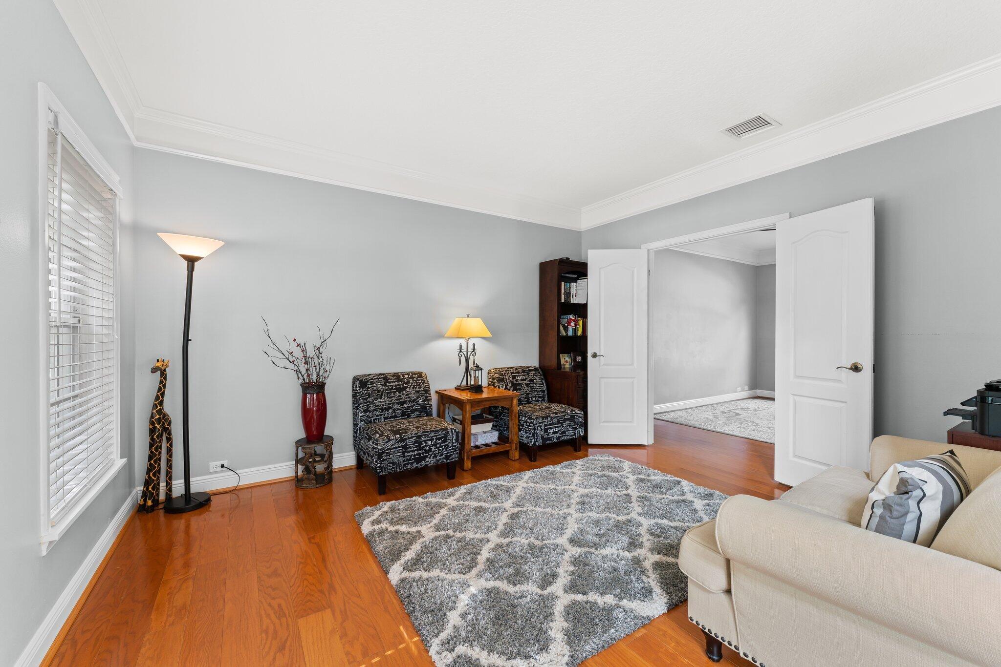203 Anhinga Lane Jupiter, FL 33458 - Photo 19 of 63 a living room with furniture and a wooden floor