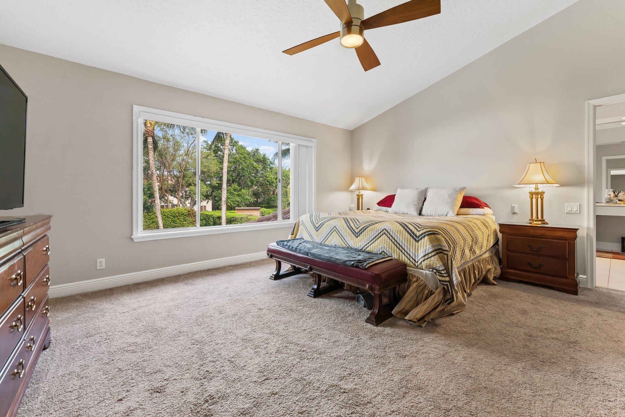 203 Anhinga Lane Jupiter, FL 33458 - Photo 25 of 63 a bed room with a bed and a television