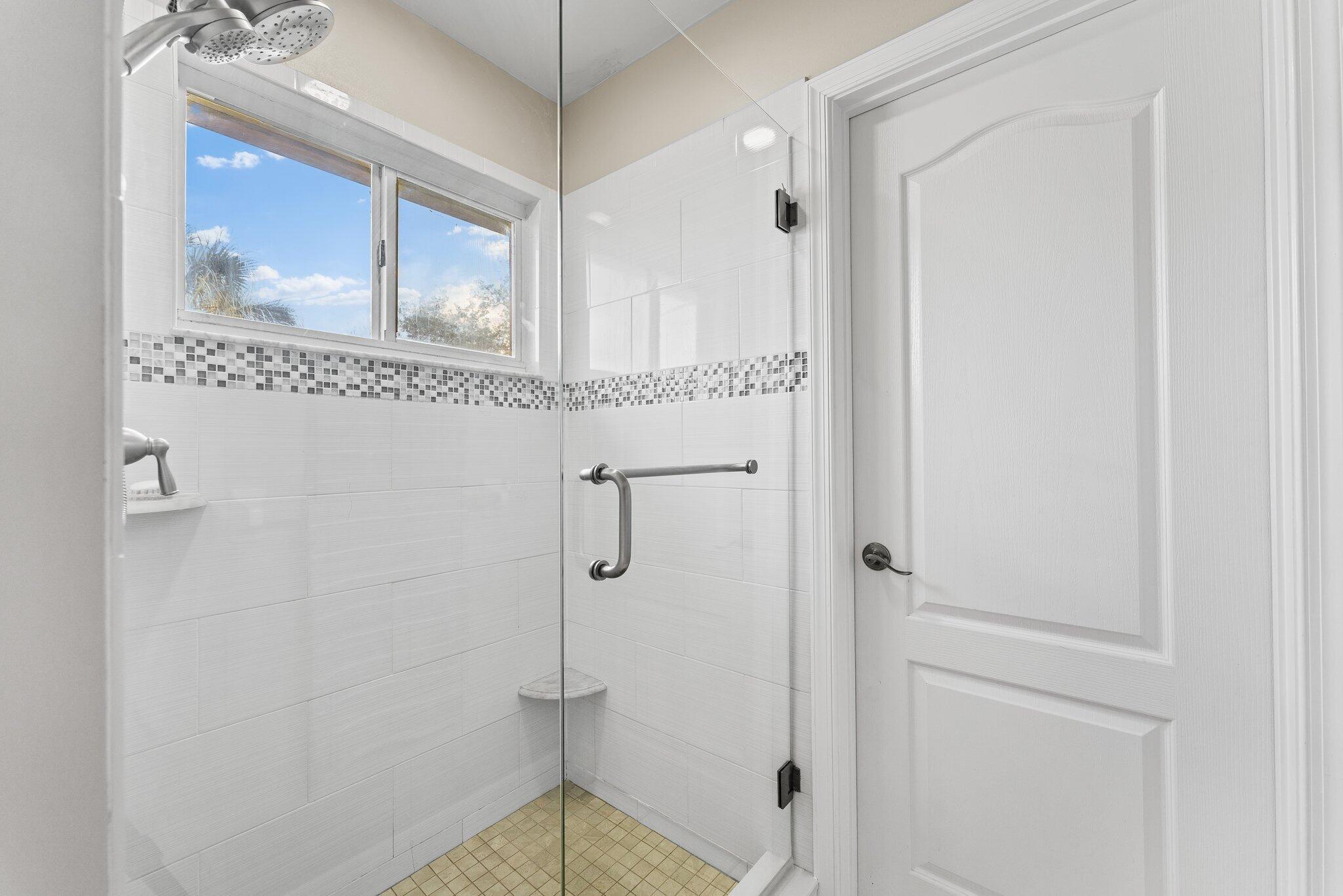 203 Anhinga Lane Jupiter, FL 33458 - Photo 32 of 63 a bathroom with a shower and a sink