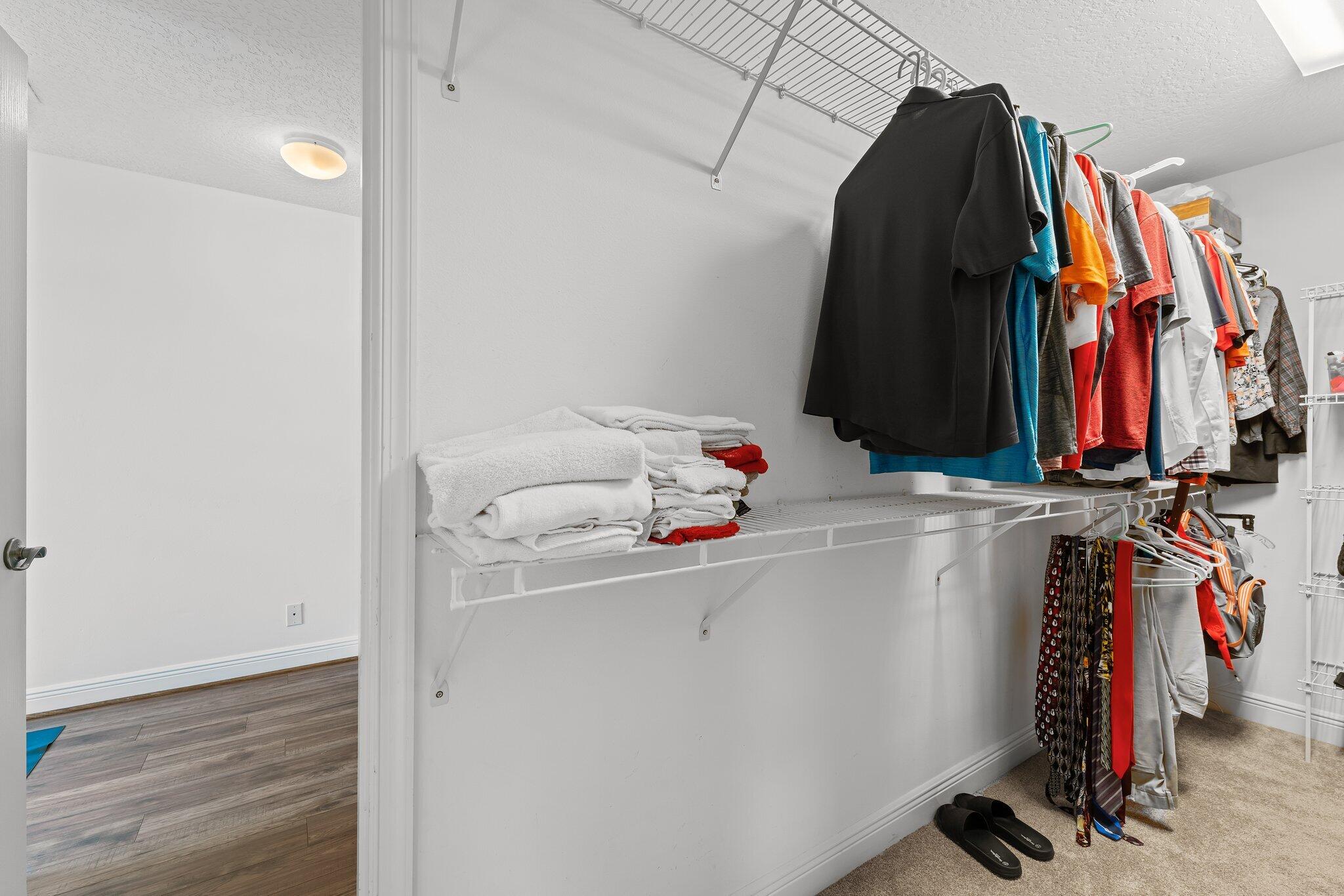 203 Anhinga Lane Jupiter, FL 33458 - Photo 33 of 63 a view of walk in closet with clothes