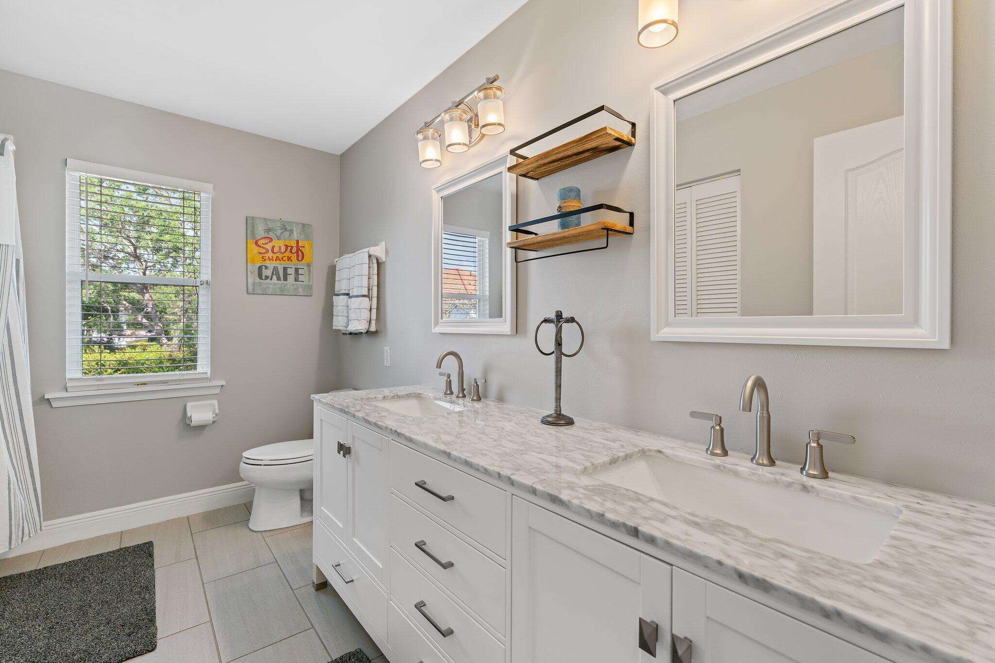 203 Anhinga Lane Jupiter, FL 33458 - Photo 37 of 63 a bathroom with a granite countertop sink mirror and toilet