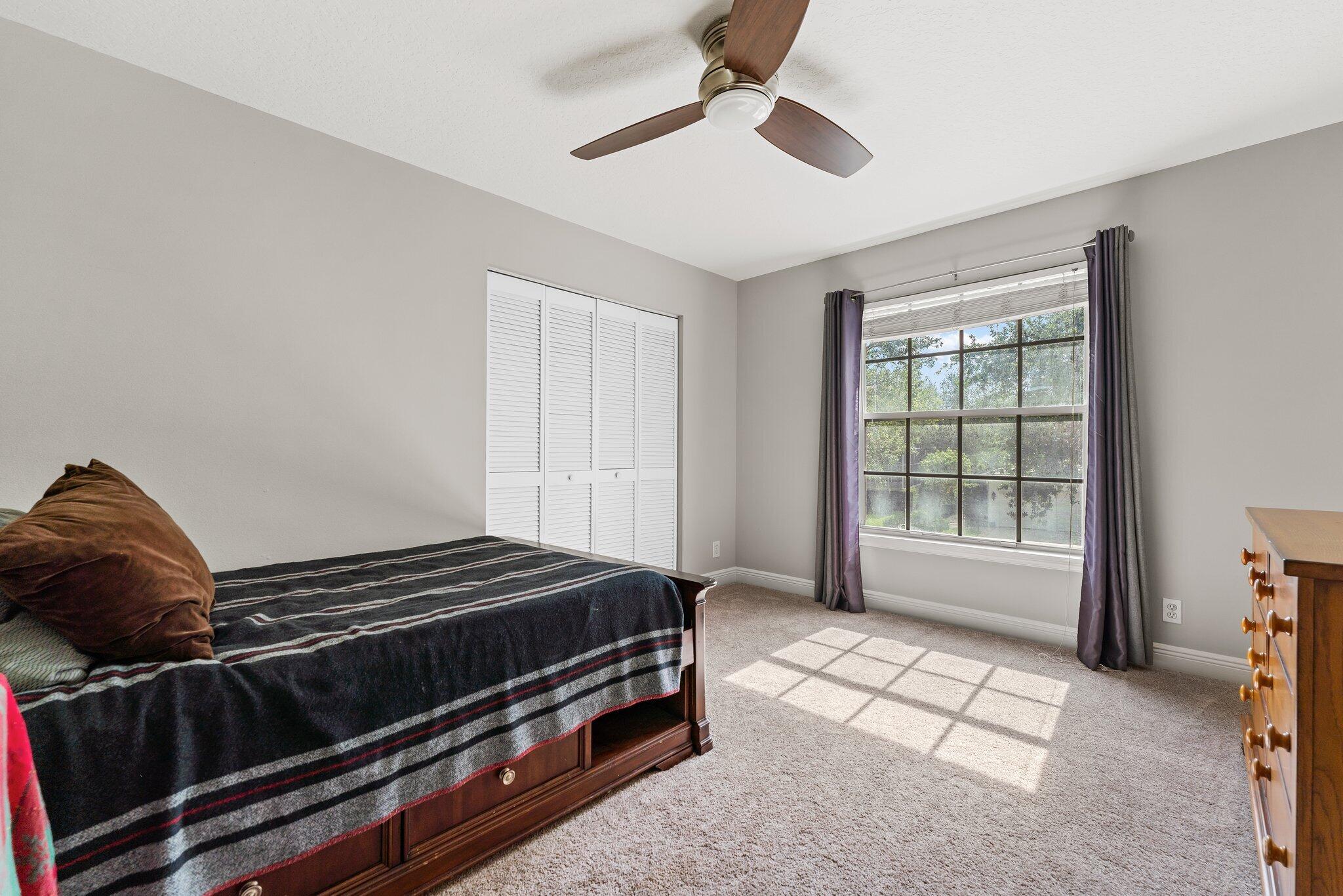 203 Anhinga Lane Jupiter, FL 33458 - Photo 39 of 63 a bedroom with a bed and a window