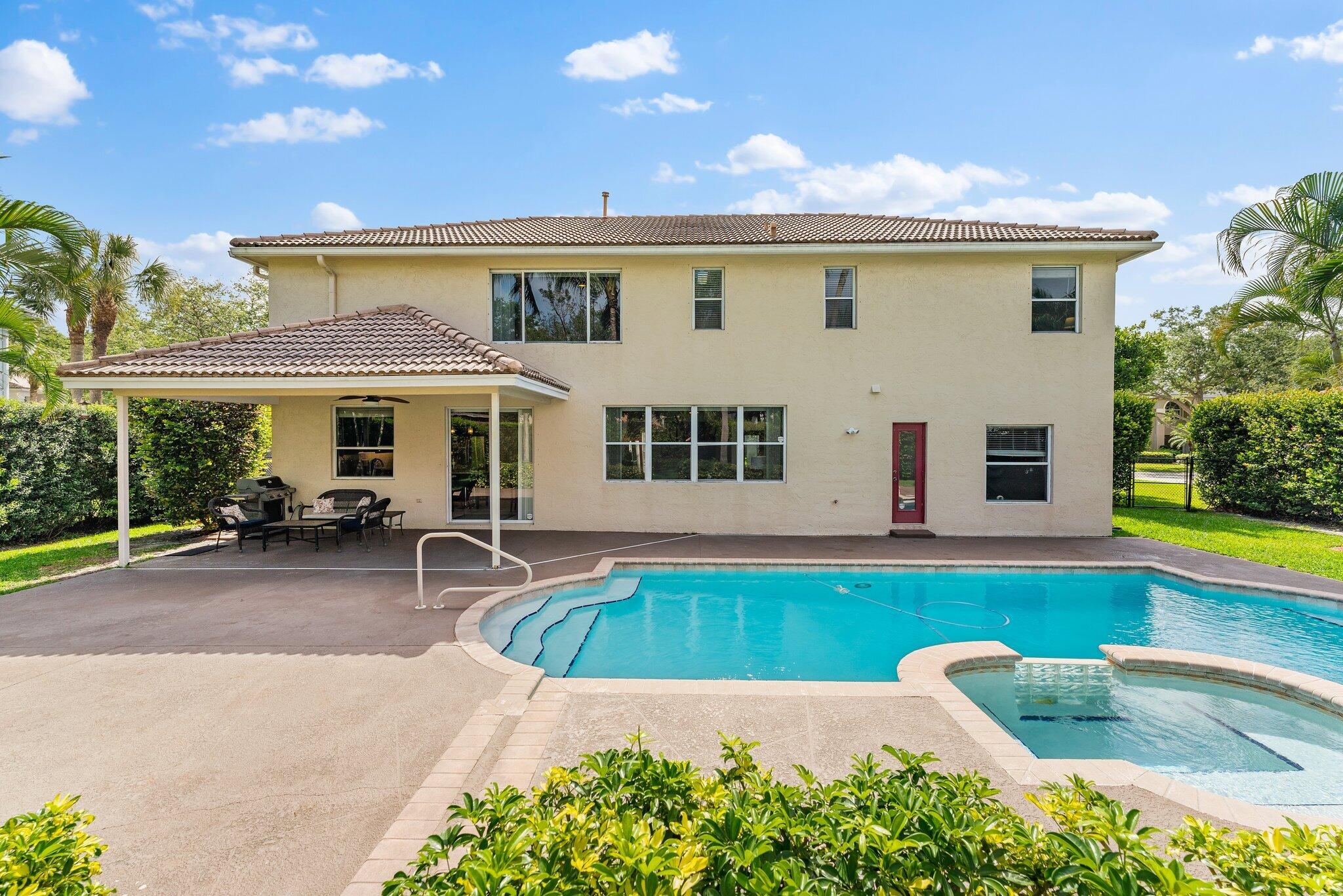 203 Anhinga Lane Jupiter, FL 33458 - Photo 44 of 63 a view of a house with swimming pool and sitting area