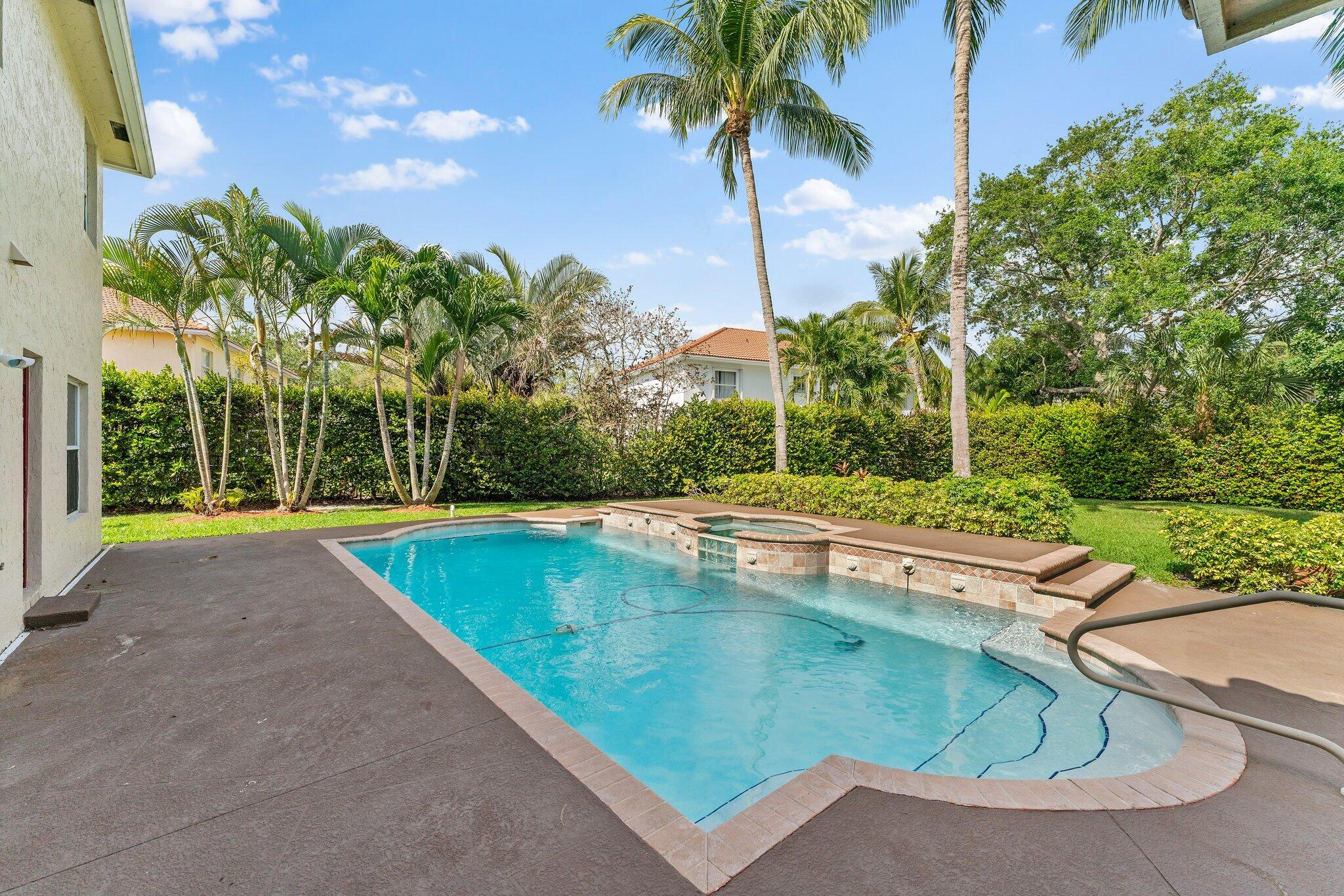 203 Anhinga Lane Jupiter, FL 33458 - Photo 48 of 63 a view of a swimming pool with a yard