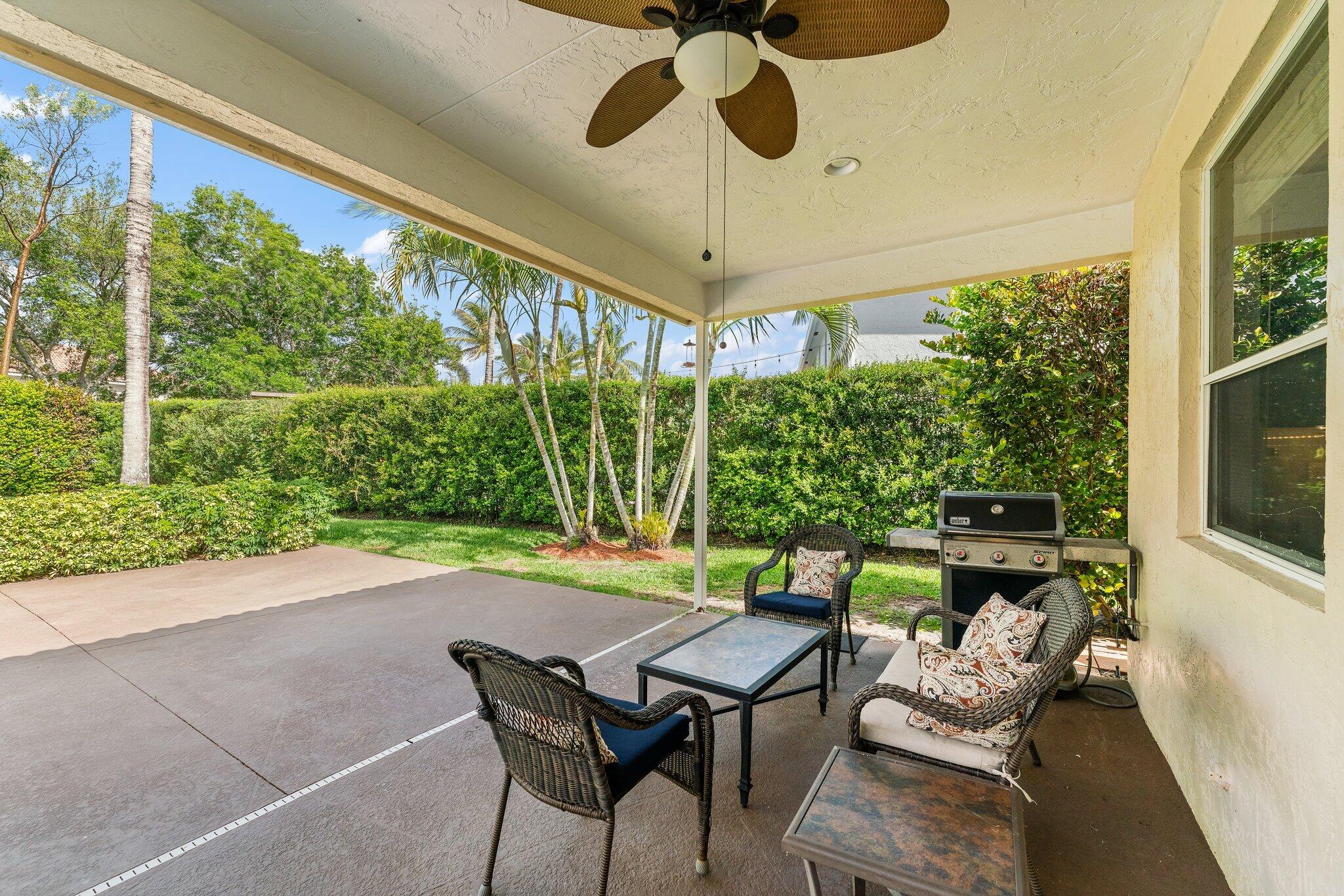 203 Anhinga Lane Jupiter, FL 33458 - Photo 50 of 63 a patio with yard glass top table and chairs