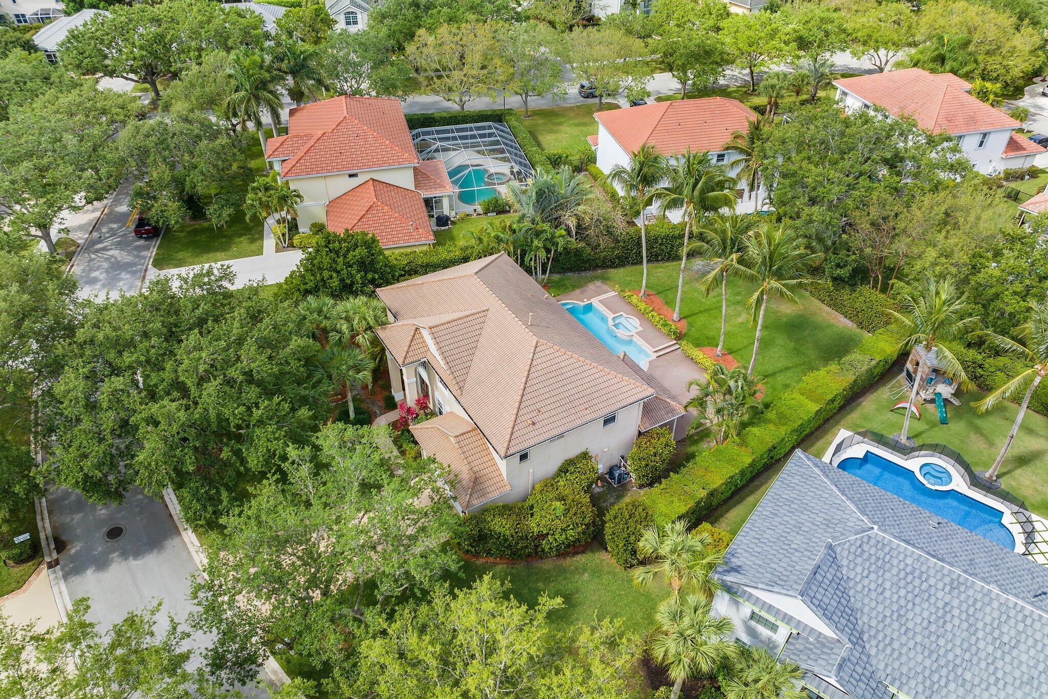 203 Anhinga Lane Jupiter, FL 33458 - Photo 55 of 63 an aerial view of a house with a garden and yard