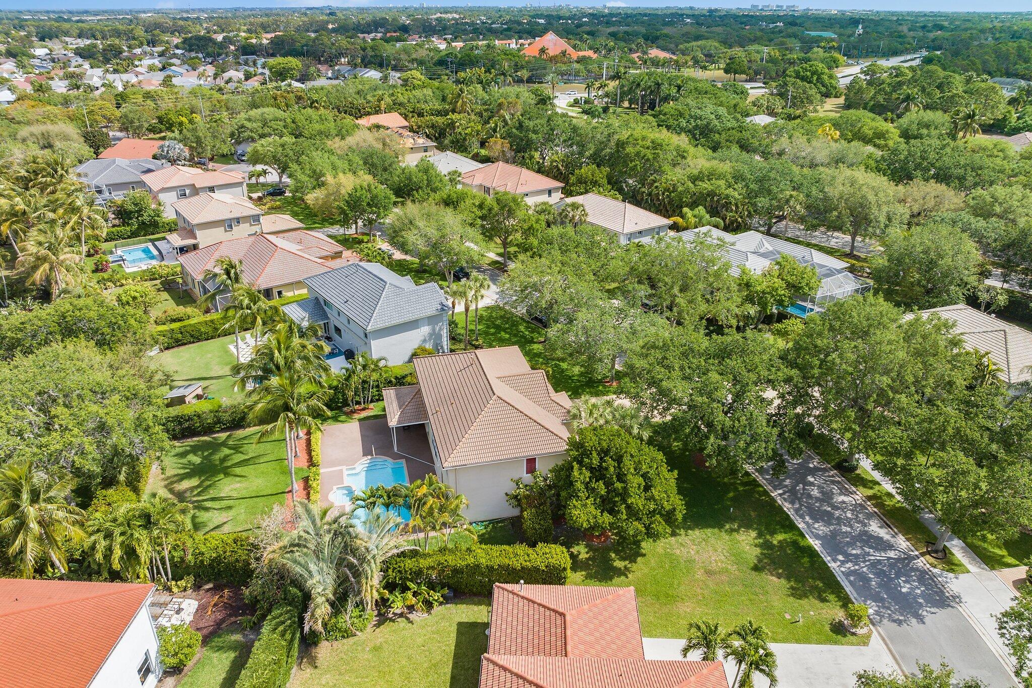 203 Anhinga Lane Jupiter, FL 33458 - Photo 57 of 63 an aerial view of residential houses with outdoor space and trees