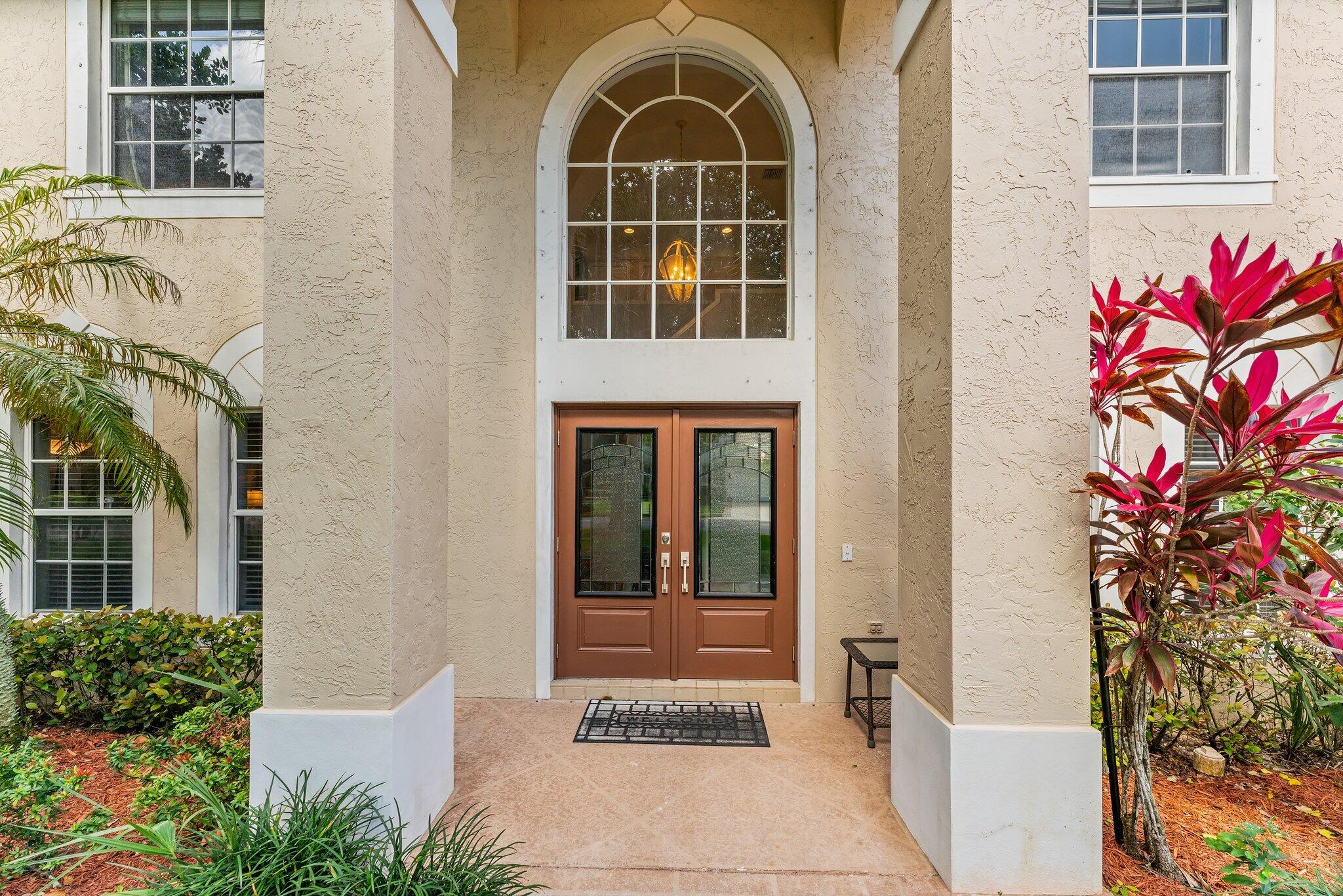 203 Anhinga Lane Jupiter, FL 33458 - Photo 63 of 63 a front view of a house with a garden