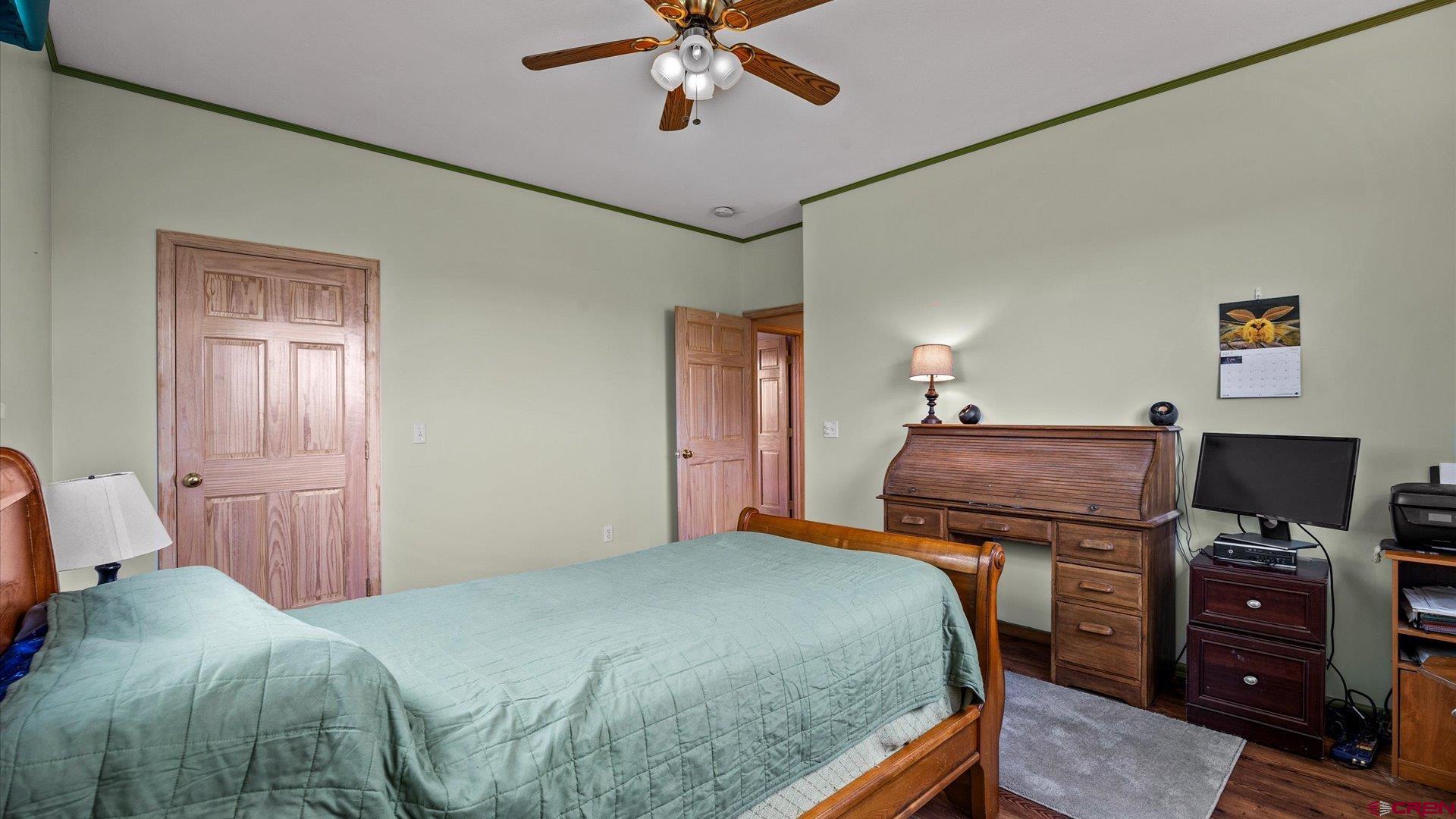 13232 B Road Delta, CO 81416 - Photo 11 of 26 a bedroom with a bed and a tv
