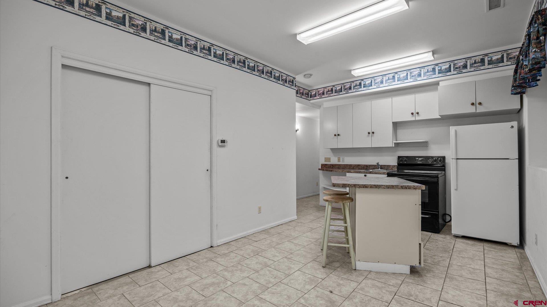 13232 B Road Delta, CO 81416 - Photo 14 of 26 a kitchen with stainless steel appliances a refrigerator and white cabinets