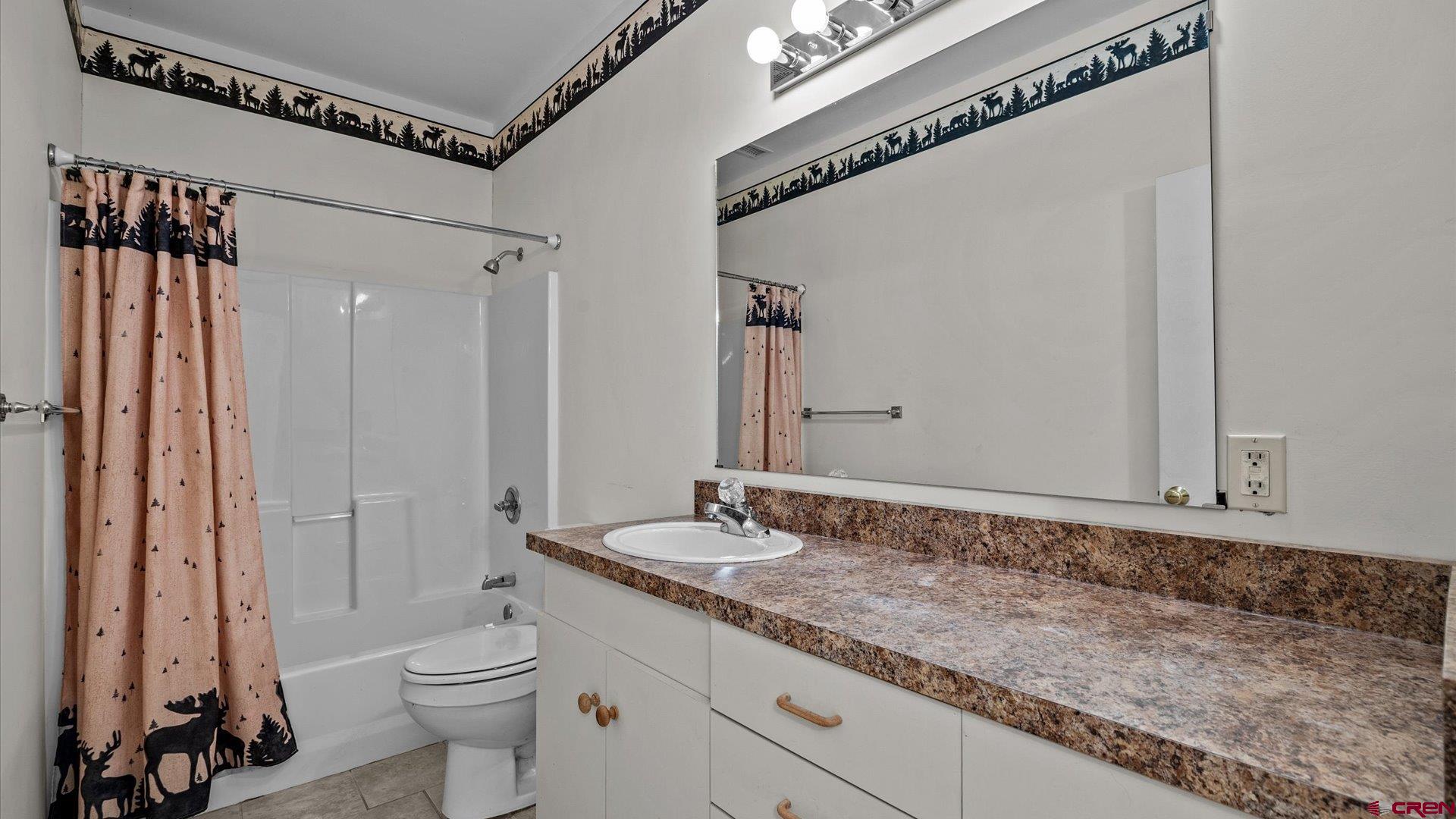 13232 B Road Delta, CO 81416 - Photo 15 of 26 a bathroom with a granite countertop sink a toilet and shower