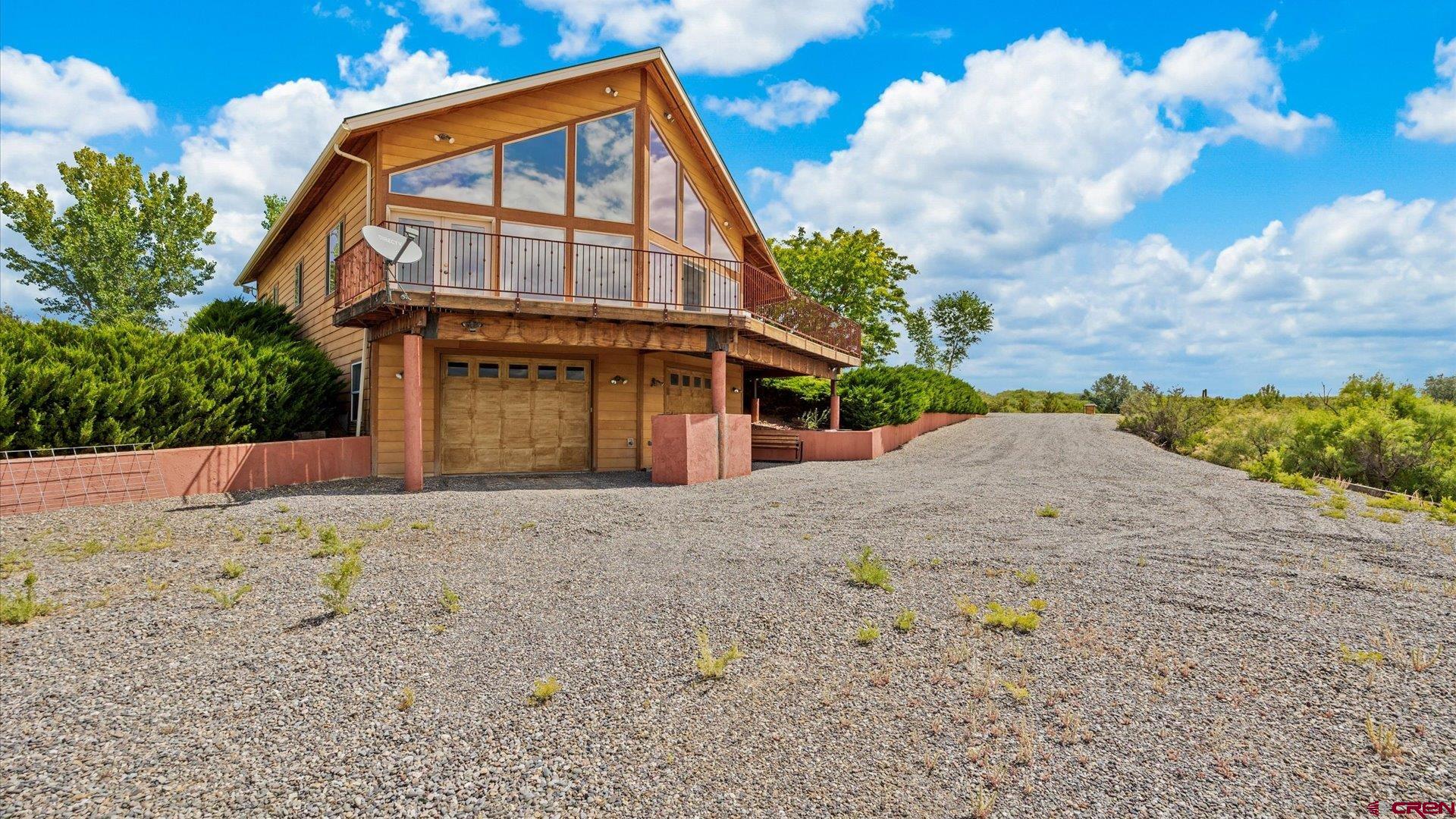 13232 B Road Delta, CO 81416 - Photo 2 of 26 a front view of a house with a yard