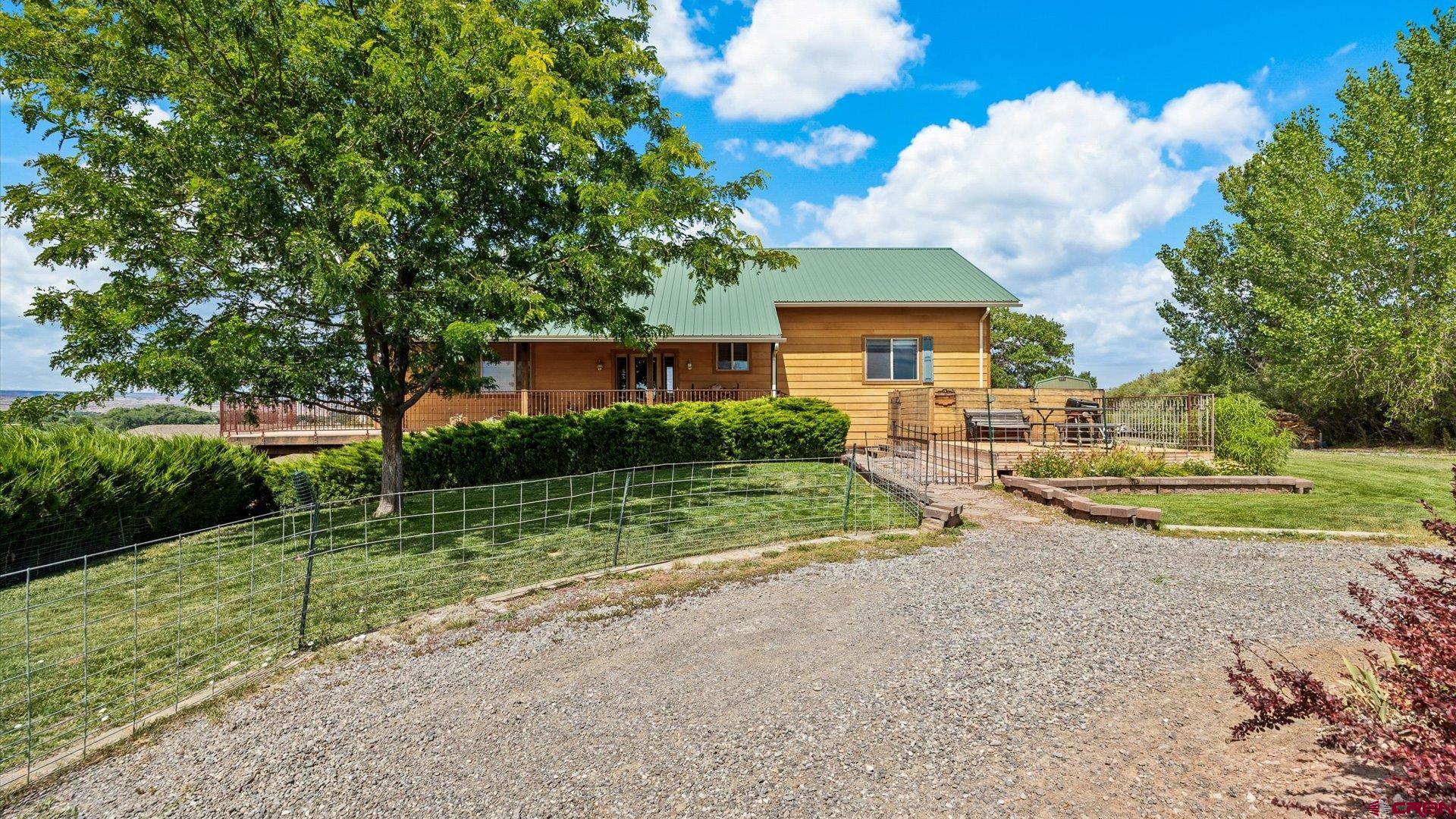 13232 B Road Delta, CO 81416 - Photo 3 of 26 a view of a house with a yard and large tree