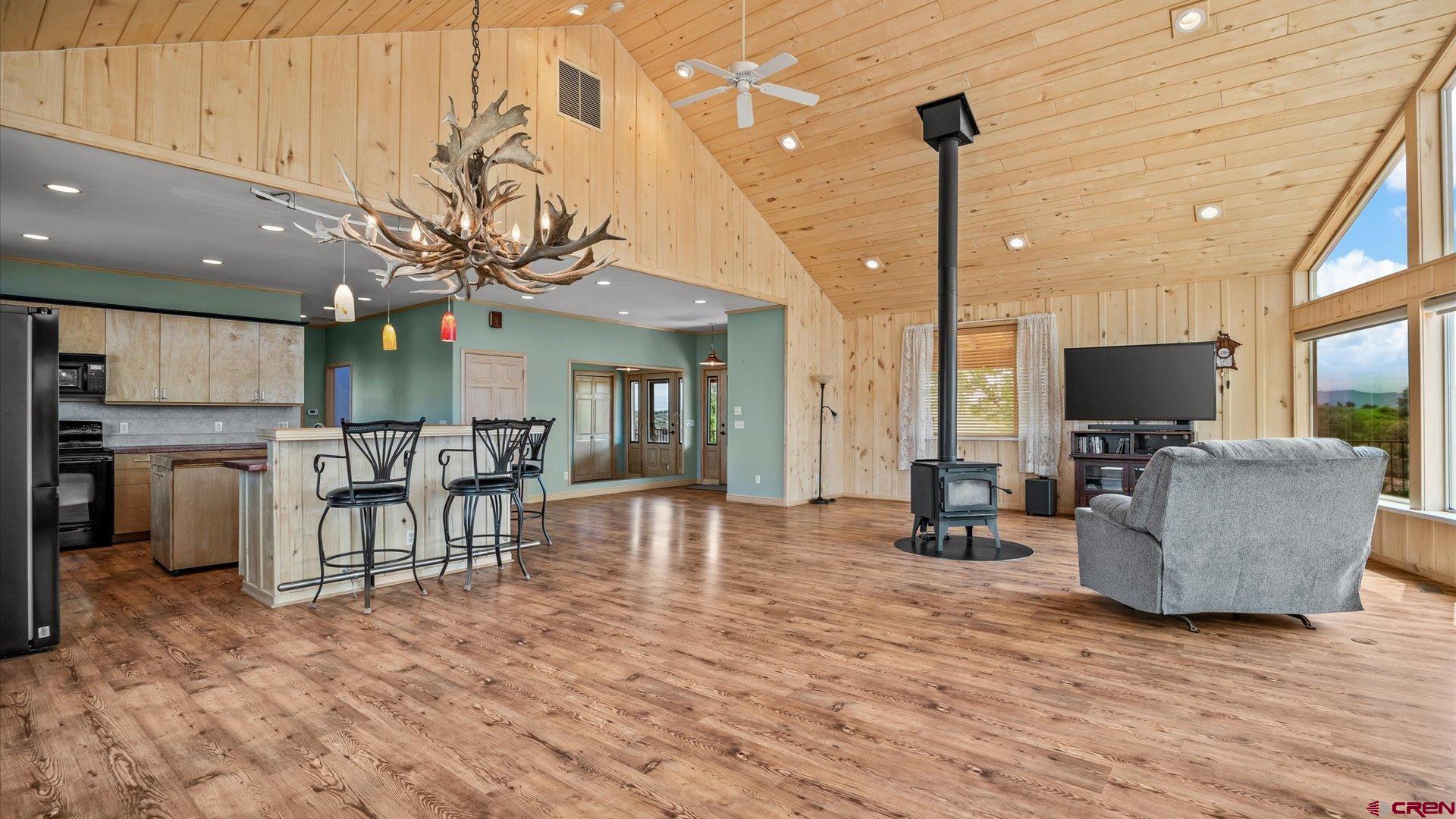 13232 B Road Delta, CO 81416 - Photo 6 of 26 a living room with furniture a flat screen tv and kitchen view