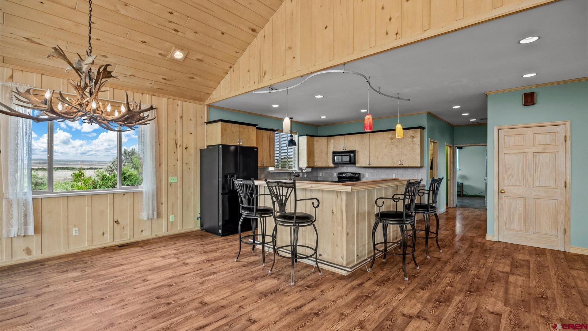 13232 B Road Delta, CO 81416 - Photo 7 of 26 a view of kitchen with refrigerator microwave and wooden floor