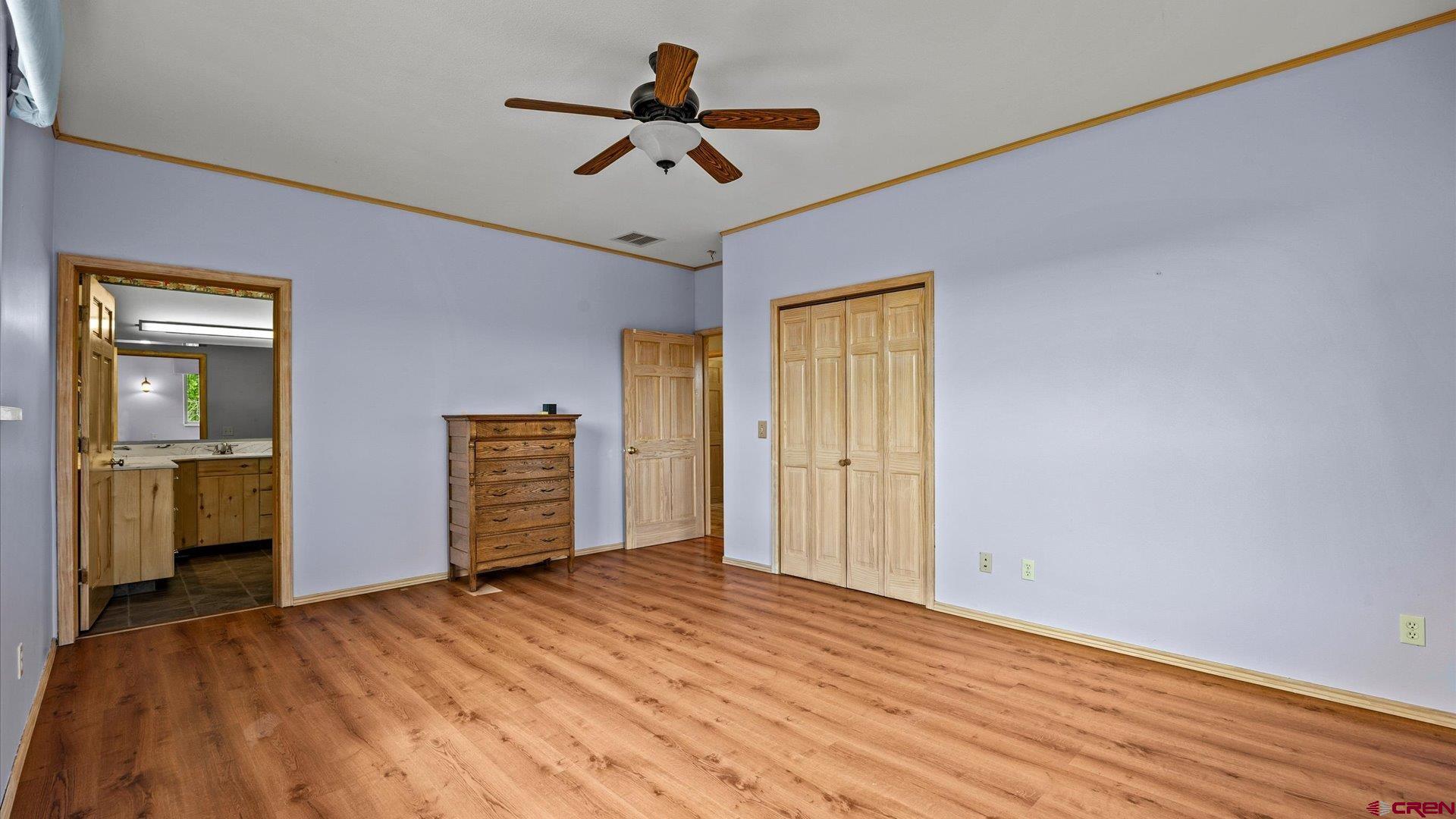 13232 B Road Delta, CO 81416 - Photo 9 of 26 a view of empty room with wooden floor and ceiling fan
