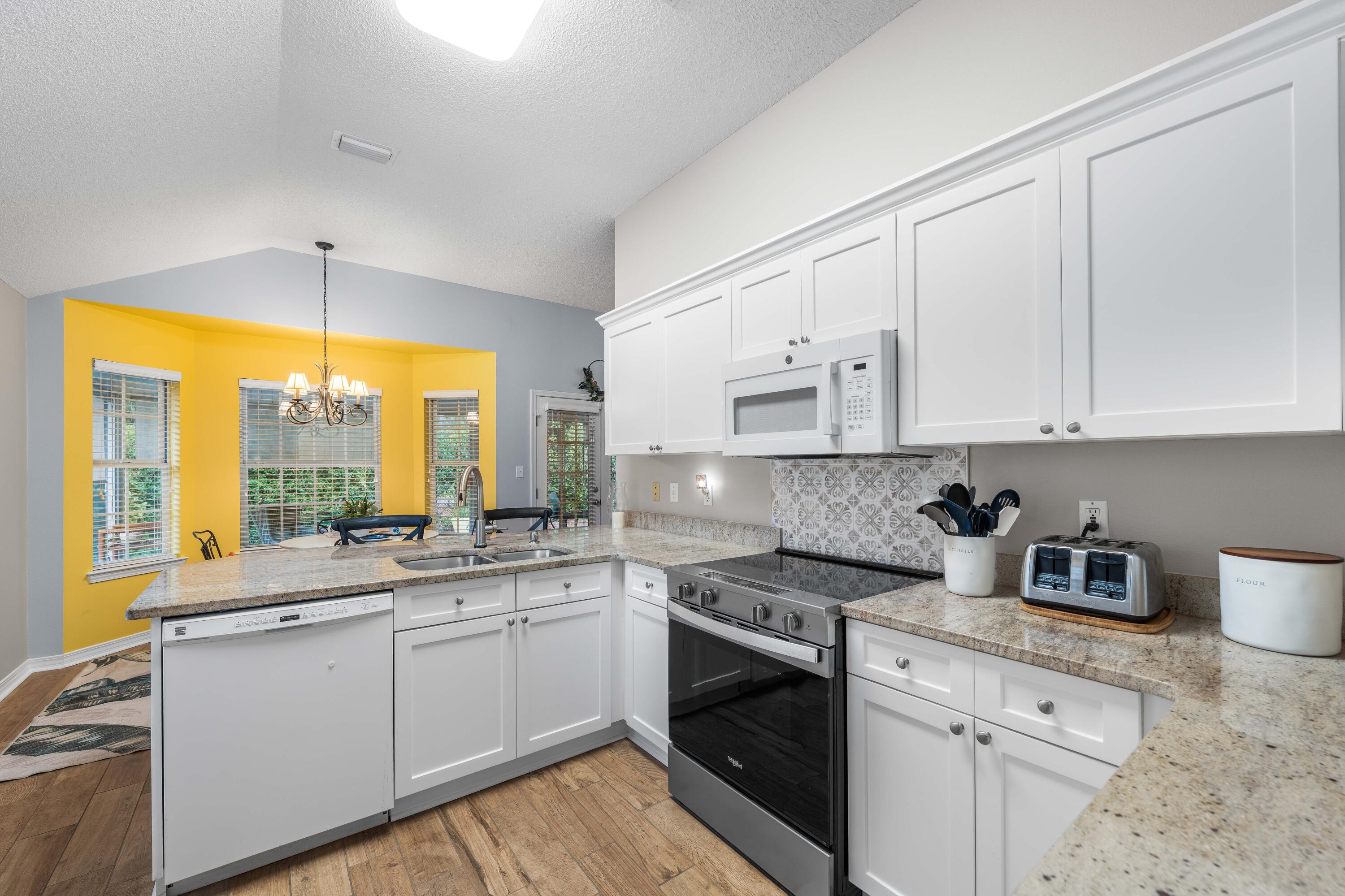 328 Bay Tree Drive Miramar Beach, FL 32550 - Photo 12 of 49 a kitchen with stainless steel appliances white cabinets and a stove top oven