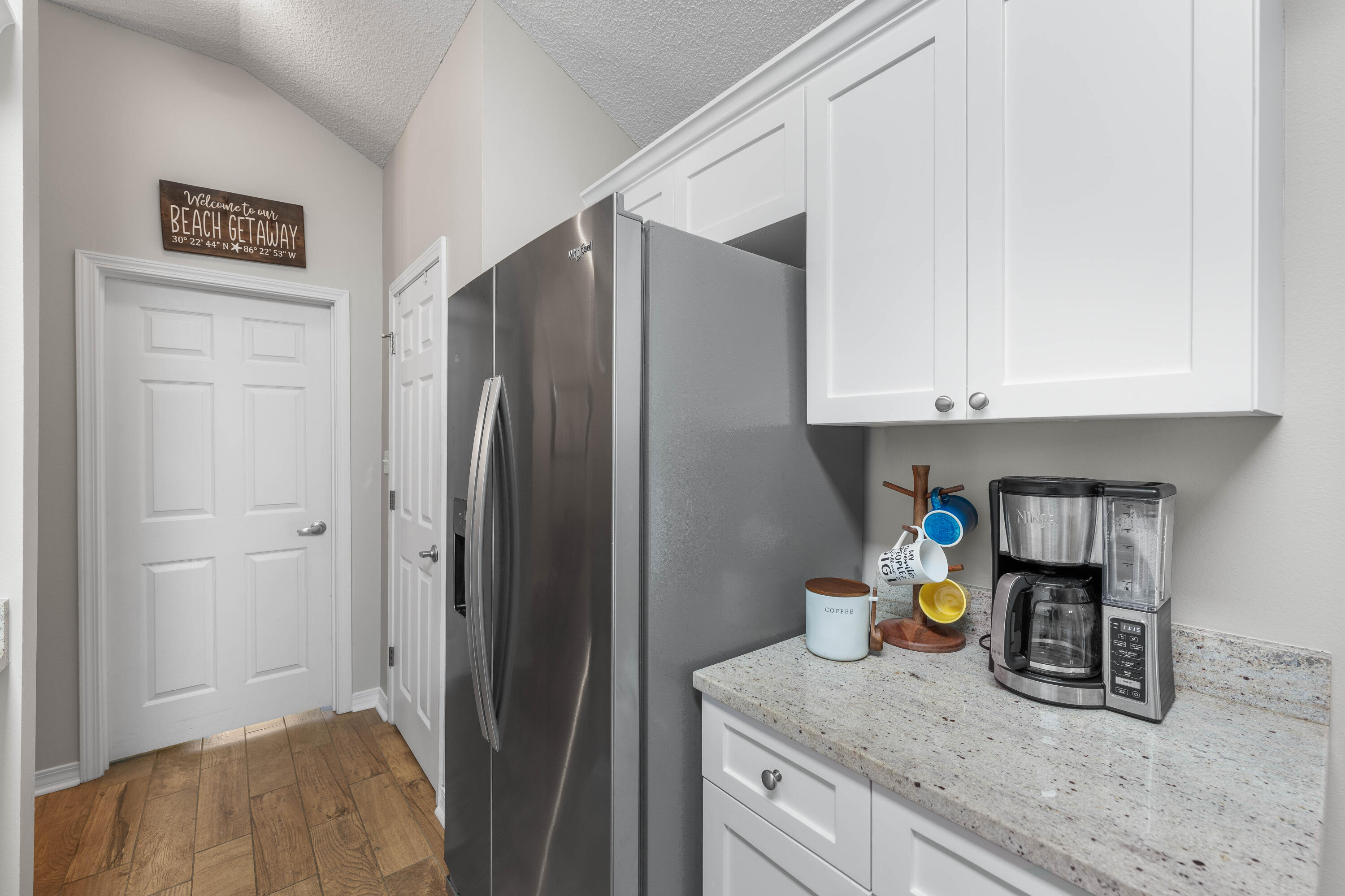 328 Bay Tree Drive Miramar Beach, FL 32550 - Photo 13 of 49 a kitchen with stainless steel appliances granite countertop a refrigerator and a white cabinets