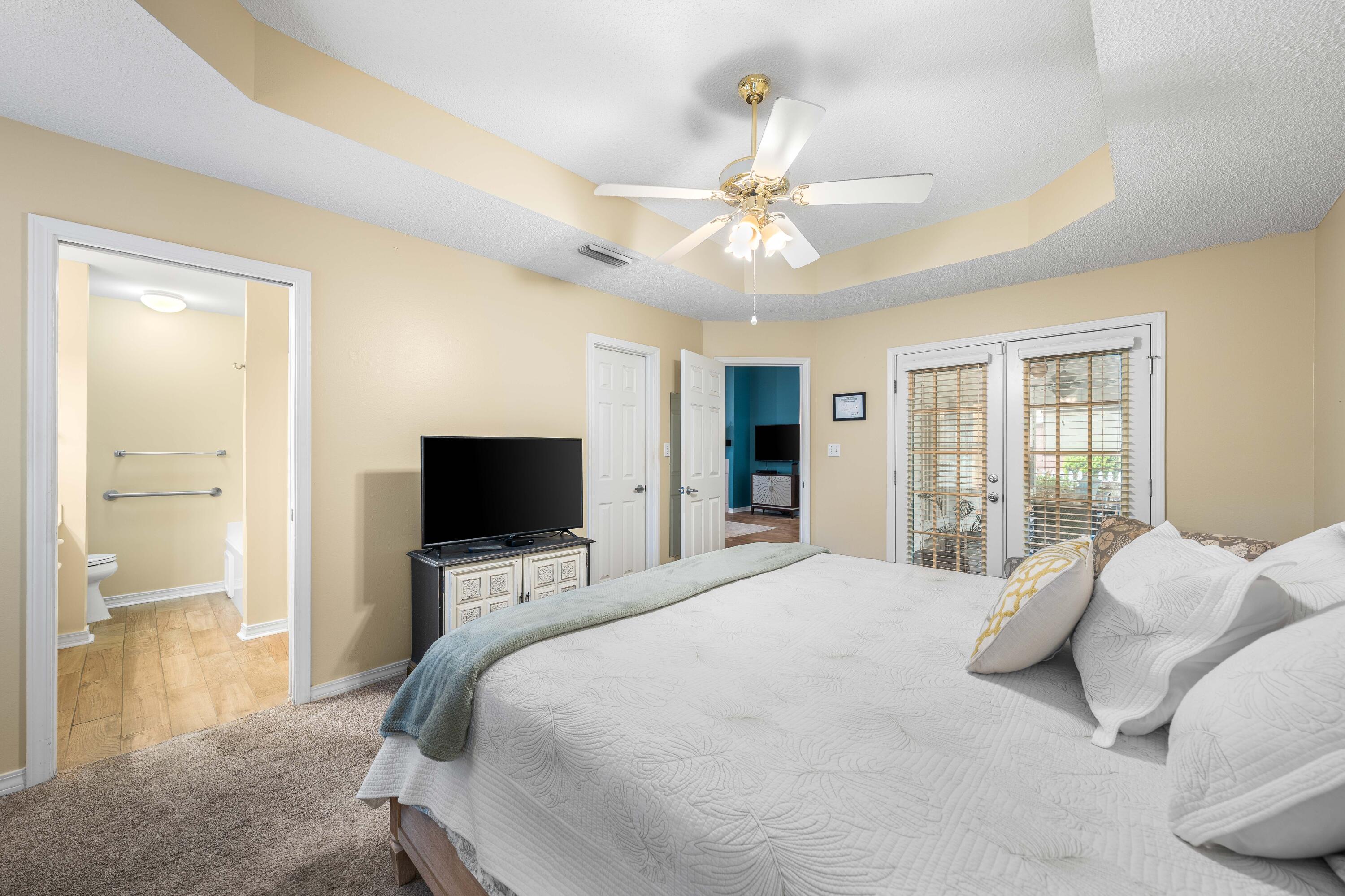 328 Bay Tree Drive Miramar Beach, FL 32550 - Photo 23 of 49 a bedroom with a large bed window and a flat tv screen