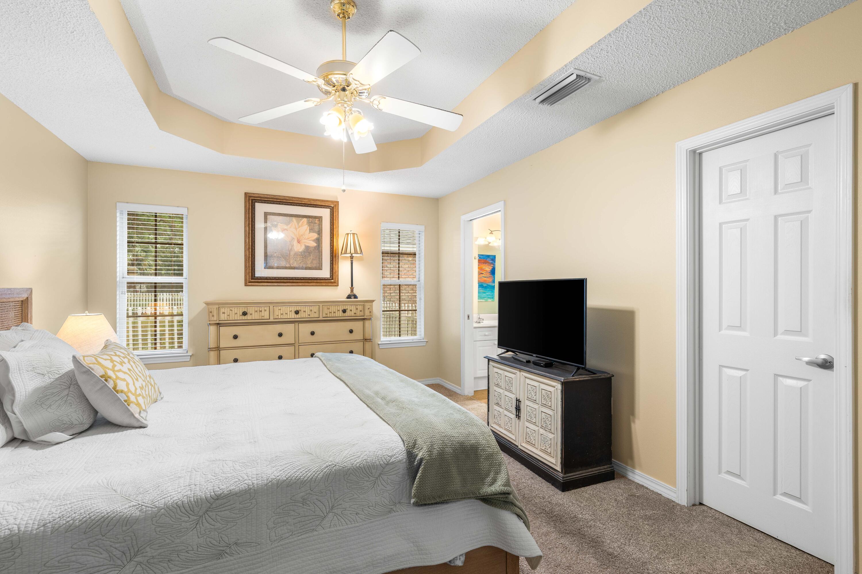 328 Bay Tree Drive Miramar Beach, FL 32550 - Photo 24 of 49 a bedroom with a large bed and a flat tv screen on a dresser