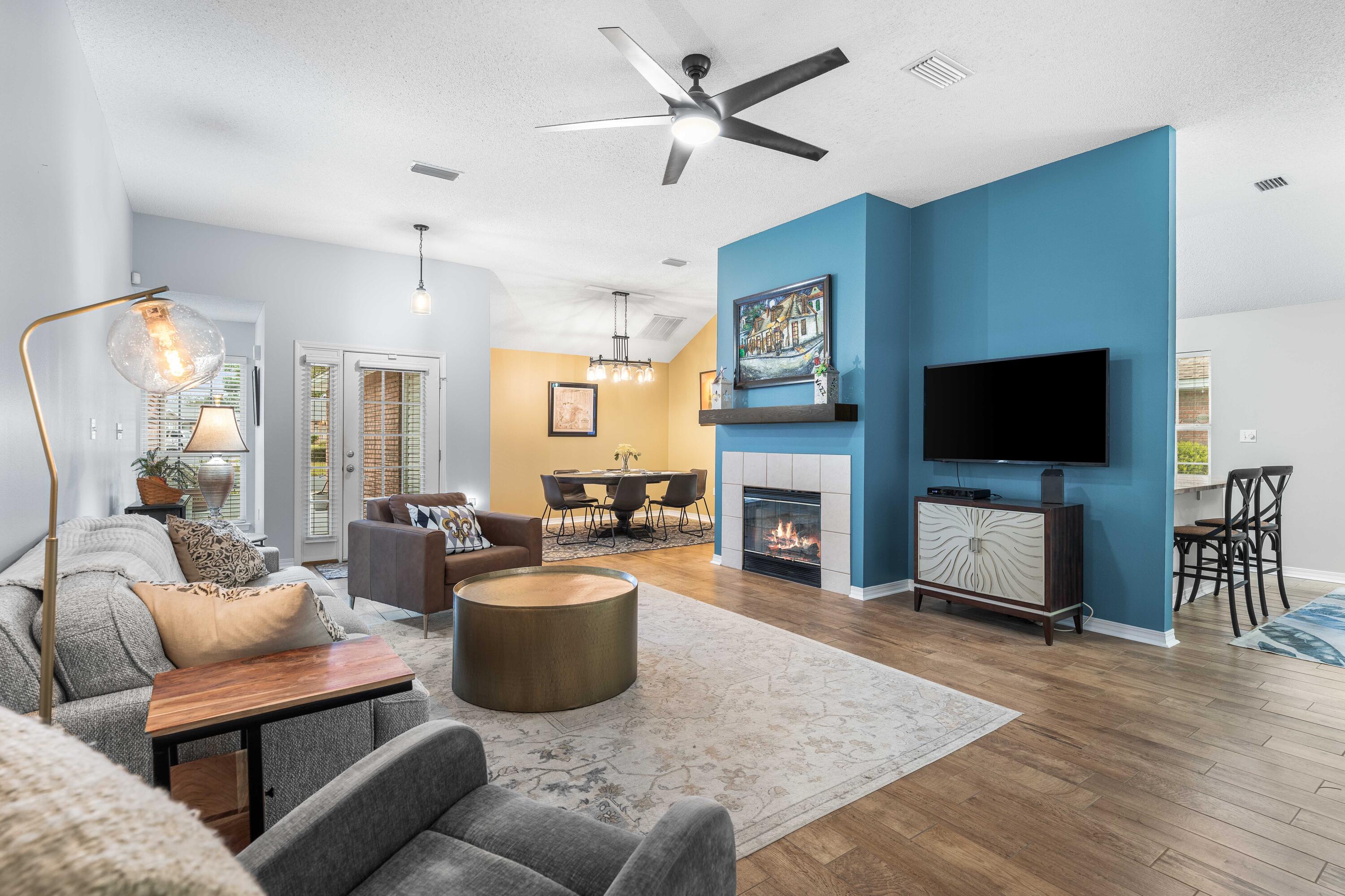 328 Bay Tree Drive Miramar Beach, FL 32550 - Photo 5 of 49 a living room with furniture a flat screen tv and a fireplace
