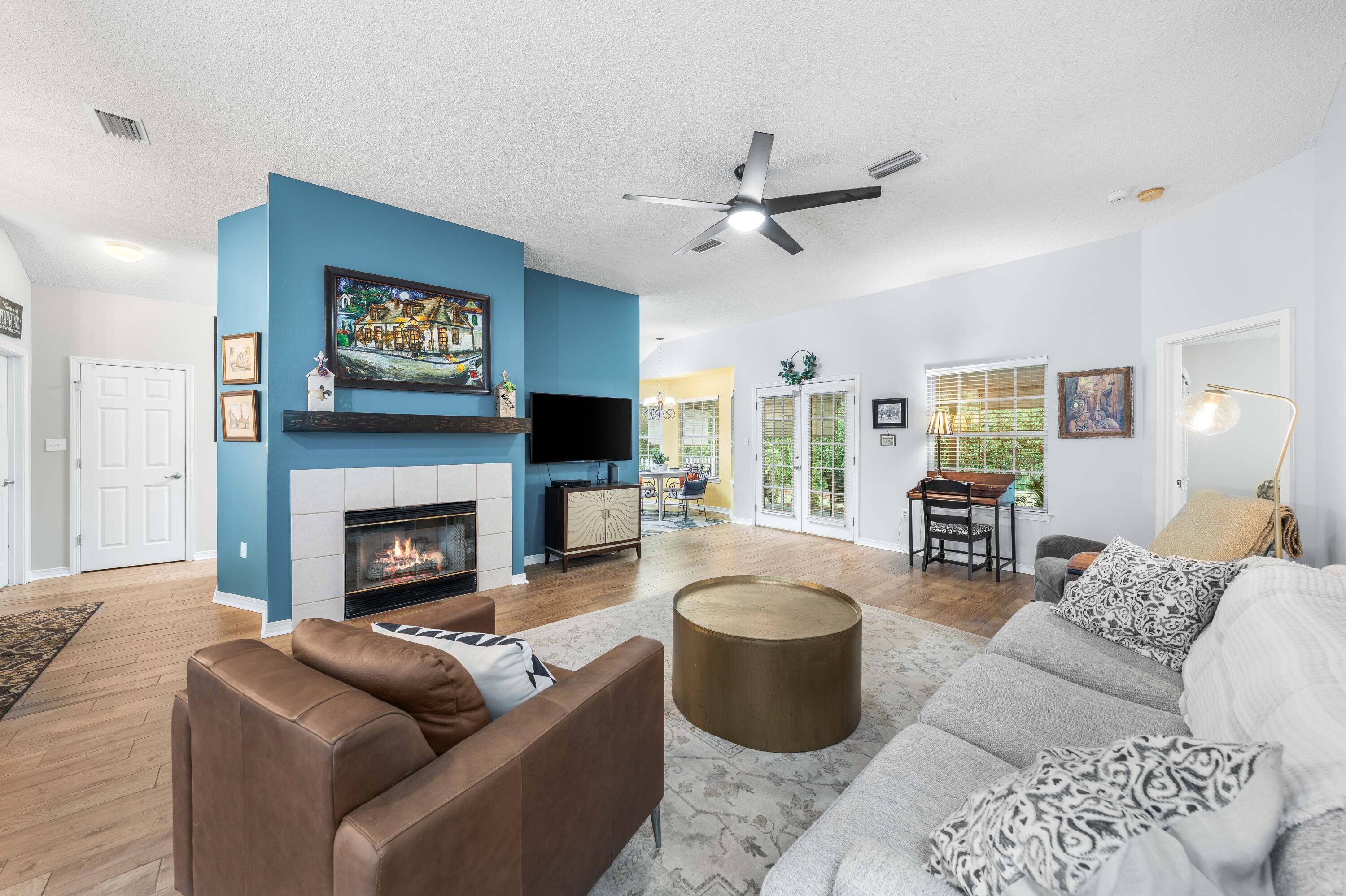 328 Bay Tree Drive Miramar Beach, FL 32550 - Photo 6 of 49 a living room with furniture a flat screen tv and a fireplace