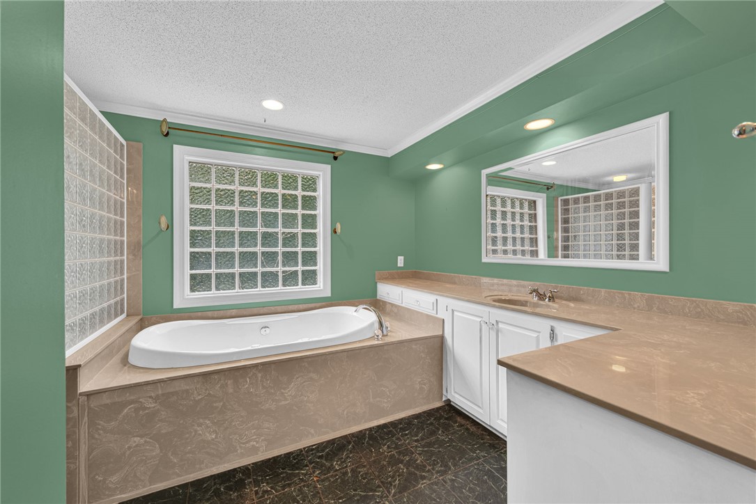 1016 Campbell Road Belton, SC 29627 - Photo 17 of 50 Indulge in a tranquil bathing experience with a luxurious soaking tub and ample counter space for personal care.