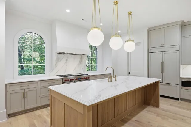 a kitchen with a sink cabinets and chandelier