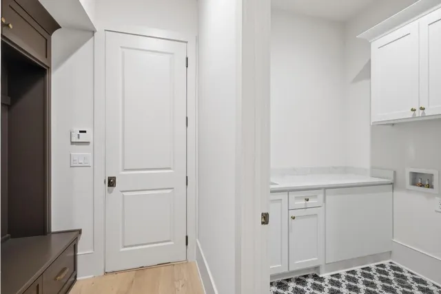 a view of a kitchen with white cabinets