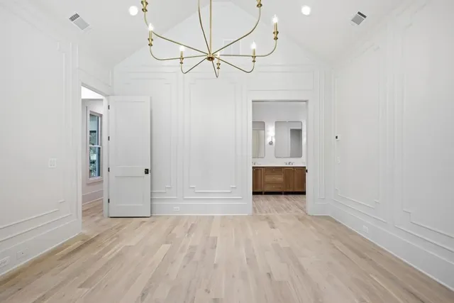 a view of a room with wooden floor and a ceiling fan