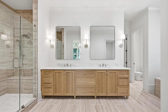 a bathroom with a double vanity sink and a mirror