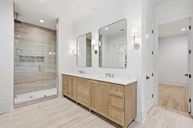 a bathroom with a shower sink and mirror