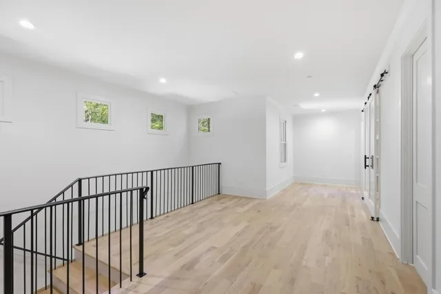 a view of hallway with wooden floor