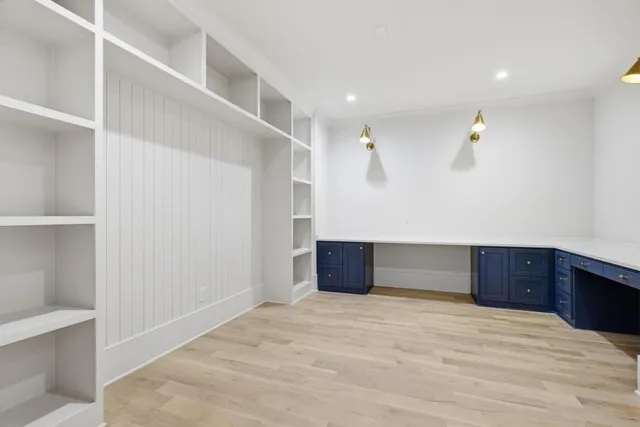 a room with a bed and cabinets