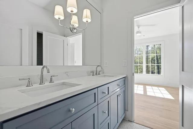 a bathroom with a sink a vanity and a large mirror
