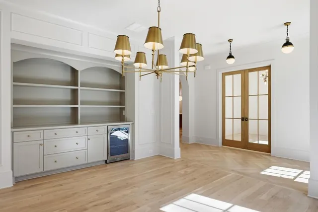 a view of an empty room with cabinet and a window