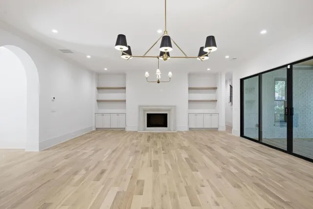 a view of an empty room with a fireplace