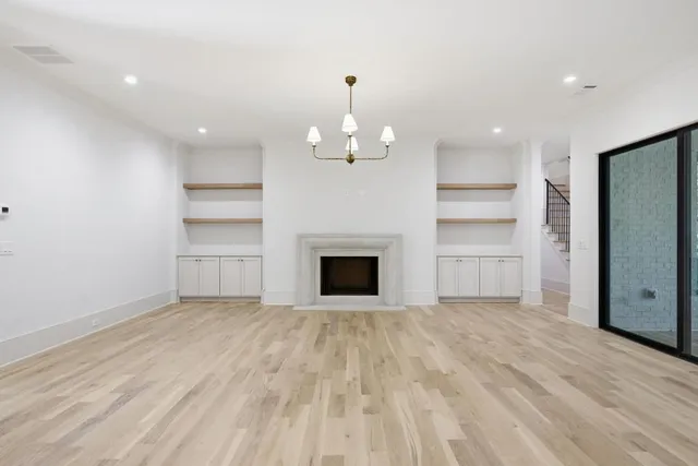 a view of a room with an empty room and a fireplace
