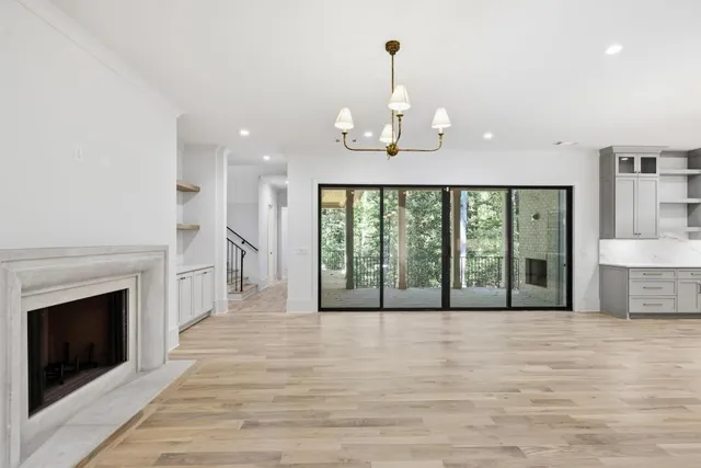 a view of empty room with wooden floor and fireplace