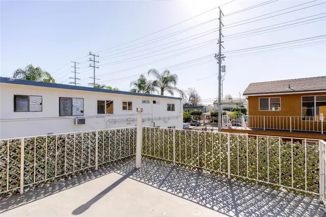 a view of a house with a wooden fence