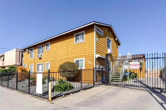 a front view of a house with iron fence