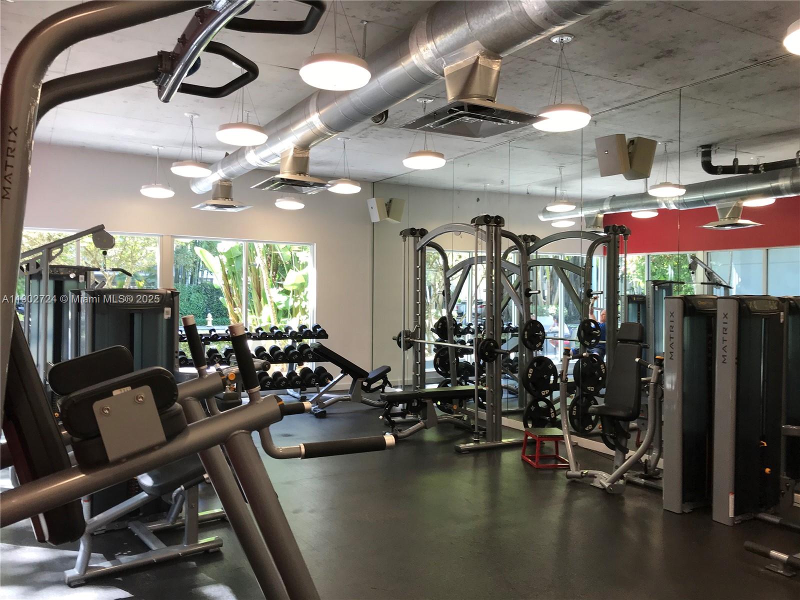 650 Northeast 64th Street, Unit G508 Miami, FL 33138 - Photo 11 of 11 a room with gym equipment and large windows