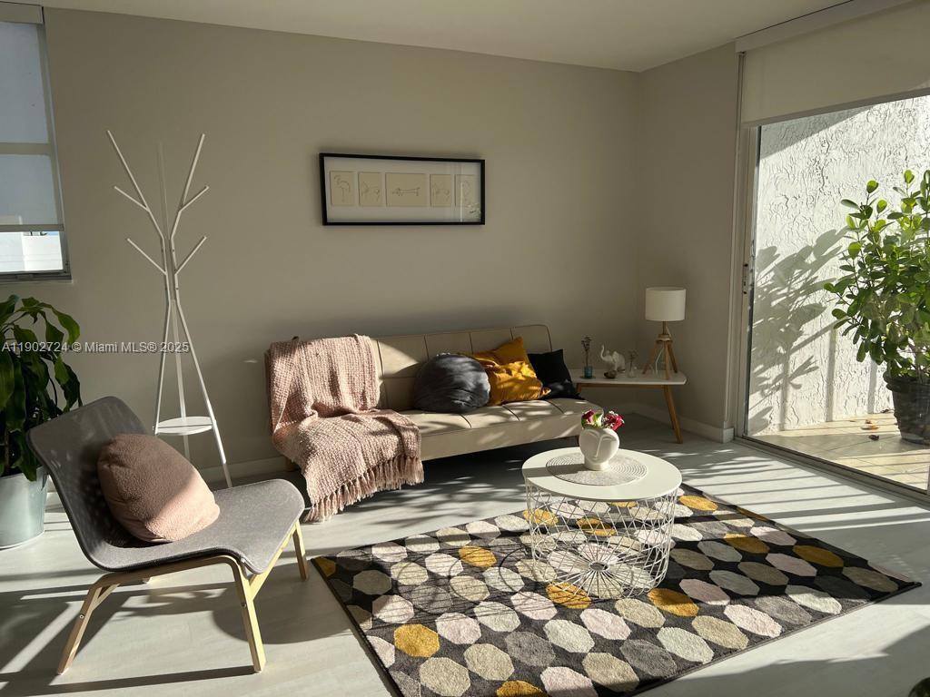 650 Northeast 64th Street, Unit G508 Miami, FL 33138 - Photo 2 of 11 a living room with furniture and a potted plant