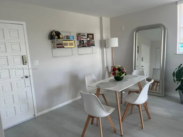 a view of a workspace with furniture and wooden floor