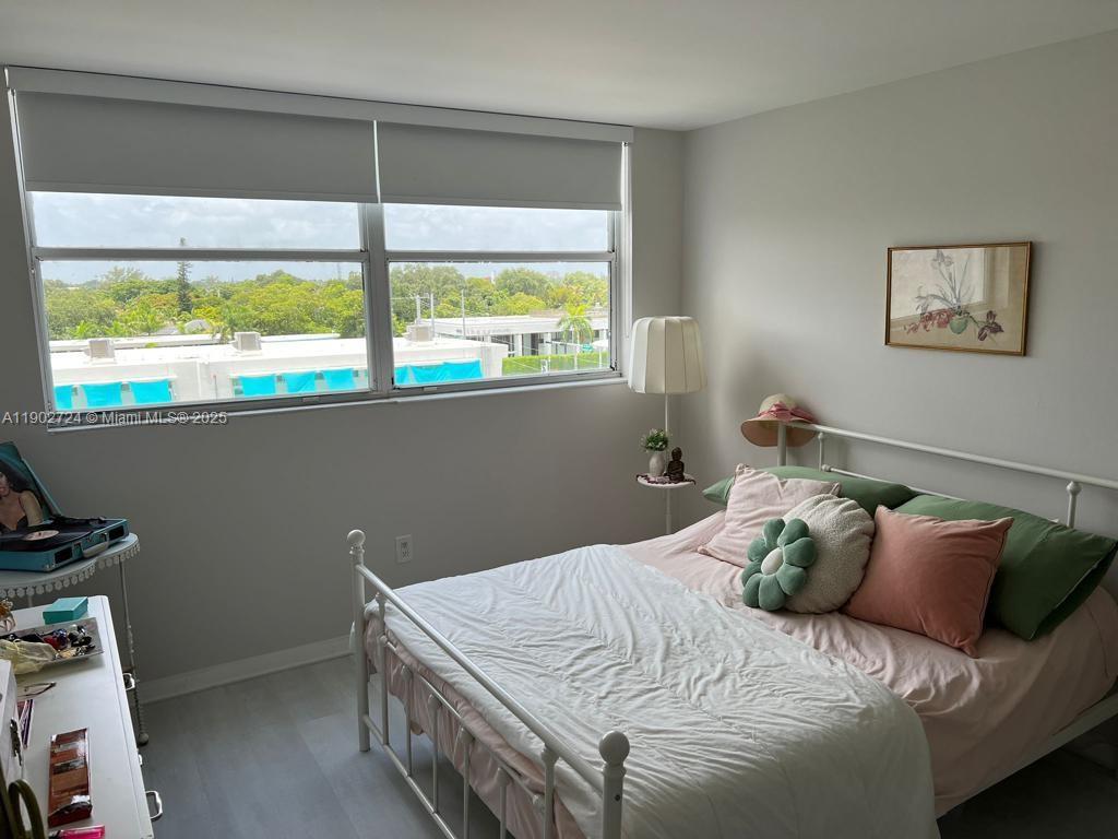 650 Northeast 64th Street, Unit G508 Miami, FL 33138 - Photo 5 of 11 a bed sitting in a bedroom next to a window