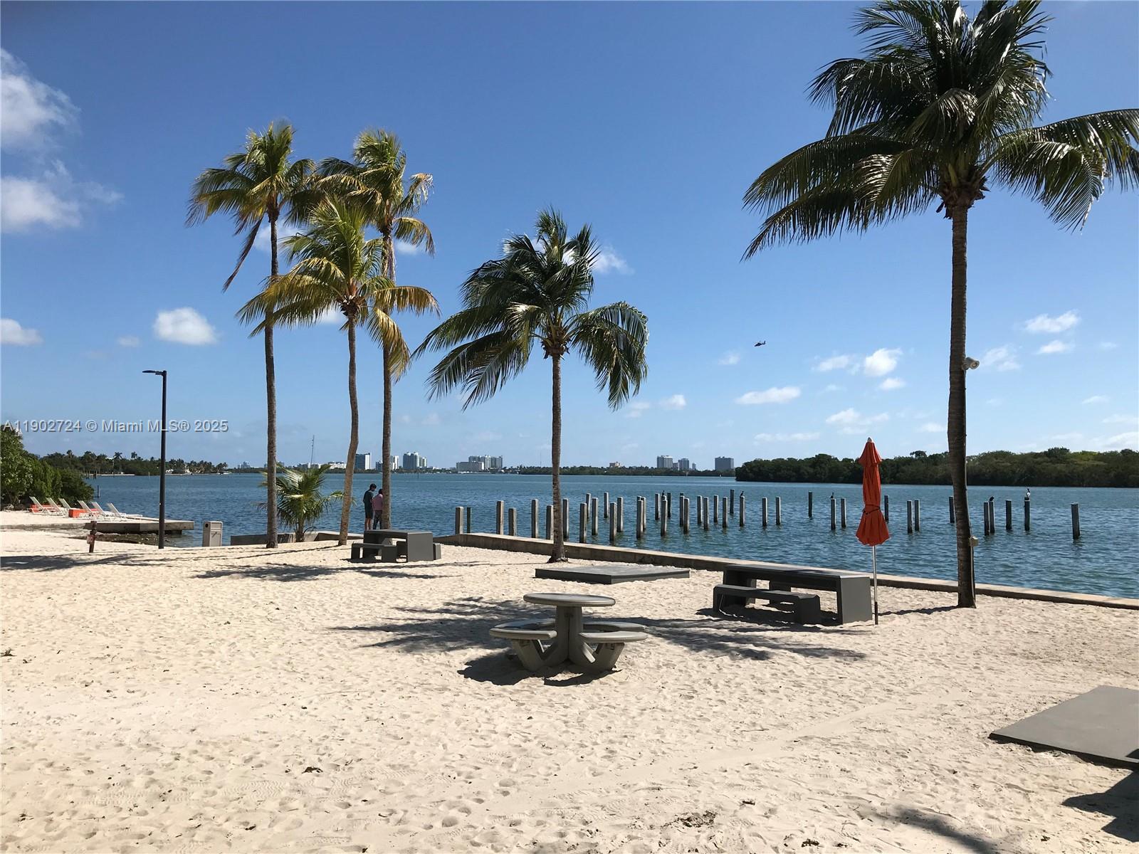 650 Northeast 64th Street, Unit G508 Miami, FL 33138 - Photo 7 of 11 a view of swimming pool with a table and chairs