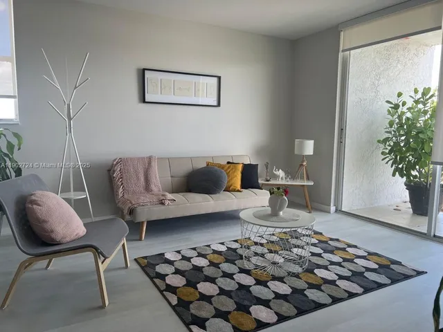 a living room with furniture and a potted plant