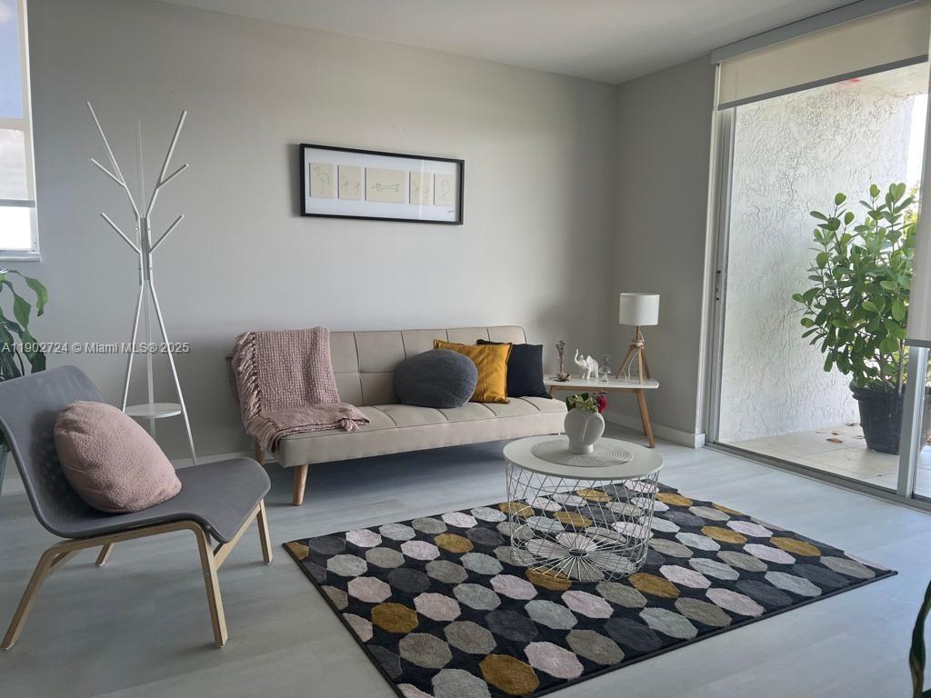 650 Northeast 64th Street, Unit G508 Miami, FL 33138 - Photo 8 of 11 a living room with furniture and a potted plant